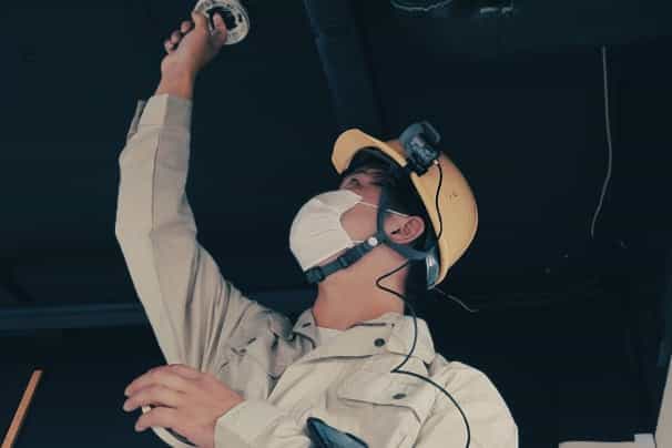 A specialist repairing a car wearing a wearable camera